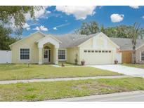 Charming single-Gathering home featuring a well-maintained lawn and a two-car garage at 1472 Bay View St, Tarpon Springs, FL 34689