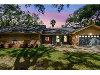 Charming single-Gathering home with a well-maintained lawn and a two-car garage at 48 Bishop Creek Dr, Safety Harbor, FL 34695