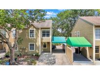 Two-story townhouse with siding and covered parking at 9050 Lake Place Ln, Tampa, FL 33634