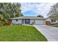 Charming single-story home with well-maintained lawn, lovely landscaping, and an attached two-car garage at 2620 49Th N Ave, St Petersburg, FL 33714