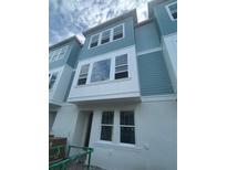 New construction townhome showcases a light blue exterior, white trim, and energy-efficient windows at 479 31St N Way, St Petersburg, FL 33713
