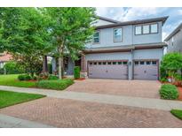 Charming two-story home with a brick driveway, two-car garage and beautifully landscaped front yard at 5724 Shell Ridge Dr, Lithia, FL 33547