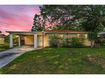 Charming single-story home with a well-manicured lawn and covered carport, perfect for Florida living at 629 Lexington St, Dunedin, FL 34698