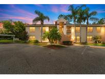 Inviting two-story condo with lush landscaping and ample parking at dusk at 7910 Hardwick Dr # 717, New Port Richey, FL 34653