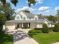 Stunning traditional two-story home with manicured landscaping, dual garages, and a welcoming front porch at 911 S Sterling Ave, Tampa, FL 33629