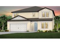 Two-story home featuring a two-car garage, manicured lawn, light colored stucco and a covered entryway at 9962 Trellis Vine Way, Parrish, FL 34219