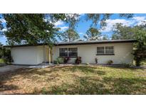 Beautifully landscaped front yard with a single-story home showcasing classic curb appeal at 1357 S Betty Ln, Clearwater, FL 33756