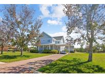 Charming two-story home featuring a brick driveway and a covered carport at 2009 153Rd E Ct, Bradenton, FL 34212