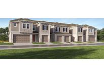 Charming townhome showcases a modern elevation with a one car garage and neutral color palette at 3469 Lapis Lake Dr, Zephyrhills, FL 33541