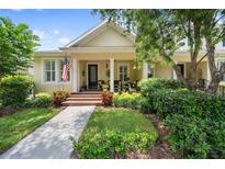 Charming home featuring a cozy front porch, lovely landscaping, and manicured lawn at 3543 Gamble St, New Port Richey, FL 34655