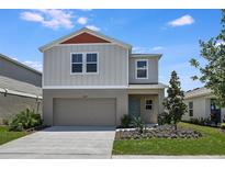 Charming two-story home features a two-car garage, well-maintained landscaping, and a welcoming front entrance at 37163 Sagemoor Dr, Zephyrhills, FL 33541