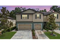 Charming two-story townhomes with individual garages, lush landscaping, and well-maintained driveways at 5344 Sylvester Loop, Tampa, FL 33610