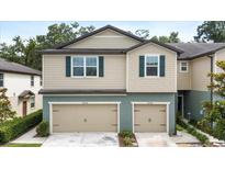 Charming two-story townhome featuring dual garages and well-maintained landscaping at 5344 Sylvester Loop, Tampa, FL 33610