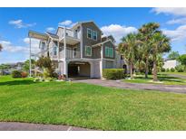 Charming condo with coastal curb appeal, lush lawn, and covered parking at 5712 Biscayne Ct # 103, New Port Richey, FL 34652