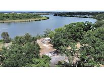 Waterfront home surrounded by mature trees, offering privacy and beautiful views of the Palm River at 6610 Myrna Dr, Tampa, FL 33619