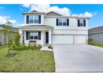 Beautiful two-story home with a three-car garage, well-kept lawn, and covered front porch at 10379 Bridgegate Heights Loop, San Antonio, FL 33576