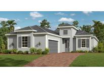 Charming single-story home with gray siding, black shutters, attached garage and well manicured lawn at 12950 Tulum Loop, Venice, FL 34293