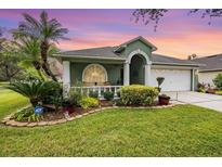 Charming single-Gathering home with a well-manicured lawn, columns and garden at 1932 Sean Wood Cir, Brandon, FL 33510