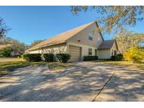 Charming single-Gathering home featuring a two-car garage, well-maintained landscaping, and a welcoming entrance at 2870 Rampart Cir, Clearwater, FL 33761