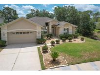 Charming single-story home featuring a meticulously landscaped front yard and a two-car garage at 3350 Stonebridge Trl, Valrico, FL 33596