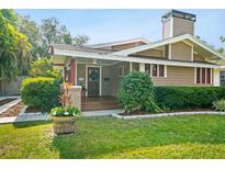 Charming craftsman home featuring a well-manicured lawn and welcoming front porch at 5707 N Branch Ave, Tampa, FL 33604
