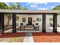 Inviting front porch with seating and decorative rug for a warm welcome at 708 53Rd N Ave, St Petersburg, FL 33703