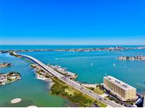 Stunning aerial view of a coastal bridge and surrounding turquoise waters under a clear blue sky at 100 Bluff View Dr # 105C, Belleair Bluffs, FL 33770