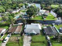 Aerial view of waterfront homes with docks and a community park with boat ramp at 10922 Park Dr, Riverview, FL 33569