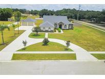 Aerial view of property featuring spacious lot, long driveway and well maintained landscaping at 13338 Jaudon Ranch Rd, Dover, FL 33527
