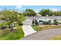 Charming one-story home with attached garage, landscaped front yard and mature trees at 1530 Ingram Dr # 1530, Sun City Center, FL 33573