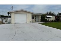 Charming single-story home featuring a one-car garage, well-maintained lawn, and a welcoming front entrance at 1542 Derrick St, Holiday, FL 34690
