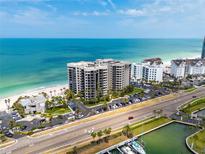 Stunning aerial view of a beachfront condo complex, showcasing its prime location and ocean views at 1600 Gulf Blvd # 1112, Clearwater Beach, FL 33767