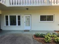 Charming condo entrance featuring large windows and manicured landscaping at 2293 Swedish Dr # 11, Clearwater, FL 33763