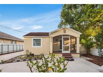 Charming home featuring a quaint screened front porch, freshly painted exterior, and driveway at 2916 W Crest Ave, Tampa, FL 33614