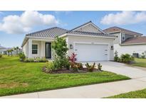 Charming one-story home featuring a well-manicured lawn and an attached two-car garage at 6281 Dry Tortugas Dr, Sarasota, FL 34241