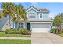 Charming two-story home with a well-manicured lawn and a two-car garage at 7710 S Desoto St, Tampa, FL 33616