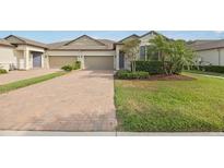 Charming townhome with well-manicured lawn and brick paver driveway at 16866 Balance Cv, Land O Lakes, FL 34638