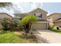 Charming two-story home with attached garage and well-maintained landscaping at 18424 Cypress Bay Pkwy, Land O Lakes, FL 34638