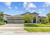 Charming single-story home features a 3-car garage and a beautifully landscaped front yard at 21642 Emory Oak Pl, Land O Lakes, FL 34637