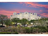 Multi-story building with blue roof accents and beautiful dusk skies at 2333 Feather Sound Dr # B309, Clearwater, FL 33762