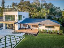 A contemporary two-story home features a stylish front yard with geometric driveway and modern architectural design at 3165 Renatta Dr, Belleair Bluffs, FL 33770