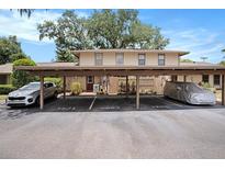 Cozy multi-Gathering home exterior showcasing assigned carport parking and well-maintained landscaping at 3203 Doe Ct, Brandon, FL 33511
