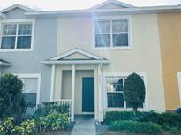 Charming townhome featuring a teal front door, well-maintained landscaping, and colorful facade at 3531 High Hampton Cir, Tampa, FL 33610