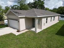 Charming single-story home featuring a one car garage and beautifully manicured lawn at 36755 Thomas Jefferson Rd, Dade City, FL 33525