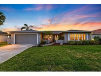 Charming single-story home boasts a manicured lawn, attached garage, and welcoming entrance, perfect for suburban living at 3912 Doral Dr, Tampa, FL 33634