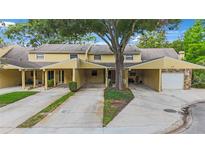 Inviting townhouse complex with covered parking and mature landscaping for a welcoming neighborhood feel at 413 Somerset Ln, Palm Harbor, FL 34684