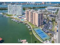 Expansive aerial view of waterfront condos, marina, tennis courts, and swimming pool at 51 Island Way # 503, Clearwater Beach, FL 33767