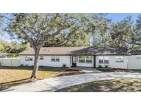 Charming white brick home with a well-manicured lawn and inviting curb appeal at 5744 150Th N Ave, Clearwater, FL 33760