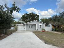 Charming single-story home with a well-maintained lawn and long driveway at 8503 N Willow Ave, Tampa, FL 33604