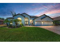 Stunning home featuring a well manicured lawn, brick paver driveway, and a fountain near the entrance at 9208 Brindlewood Dr, Odessa, FL 33556